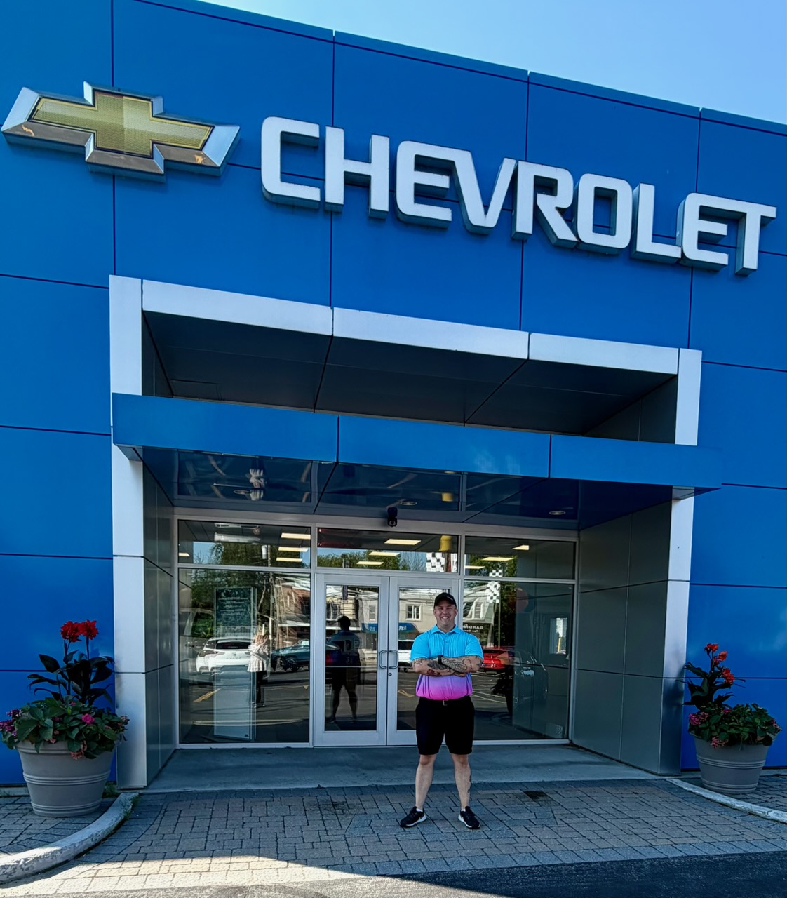 Corey Rush in front of the Chevrolet dealership