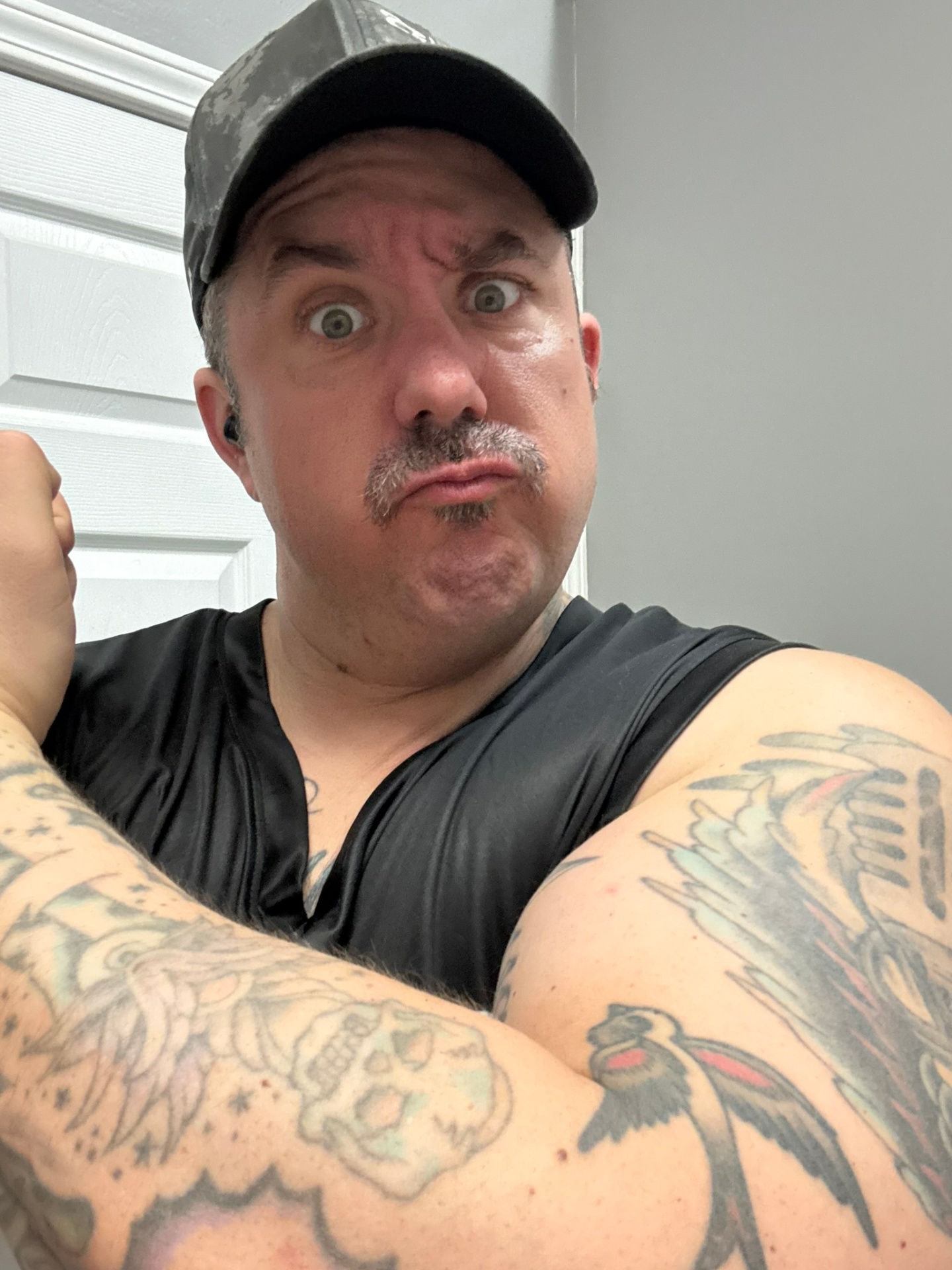 Corey Rush flexing in a black tank